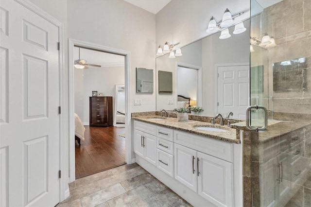 bathroom featuring vanity, ceiling fan, and walk in shower