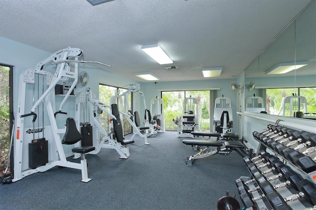 exercise room featuring a textured ceiling