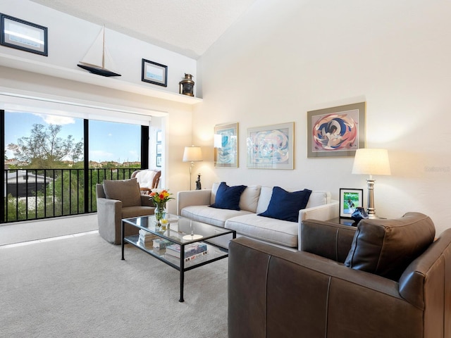 living room with high vaulted ceiling and carpet floors