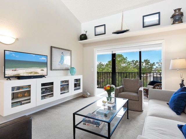 living room with high vaulted ceiling and light colored carpet