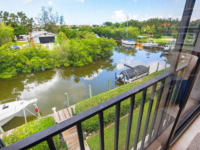 balcony featuring a water view and a boat dock