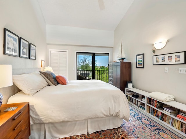 bedroom with ceiling fan, vaulted ceiling, a closet, and access to exterior