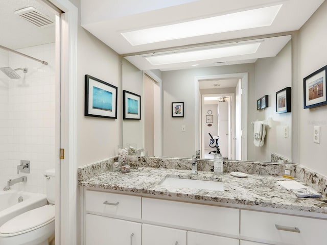 full bathroom with vanity, toilet, and tiled shower / bath