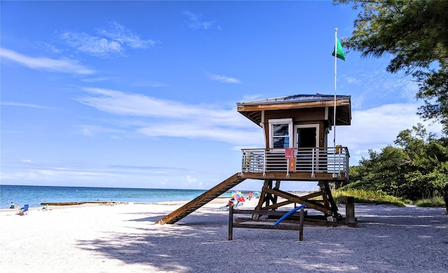 view of play area featuring a water view and a beach view