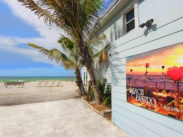 exterior space with a water view and a beach view