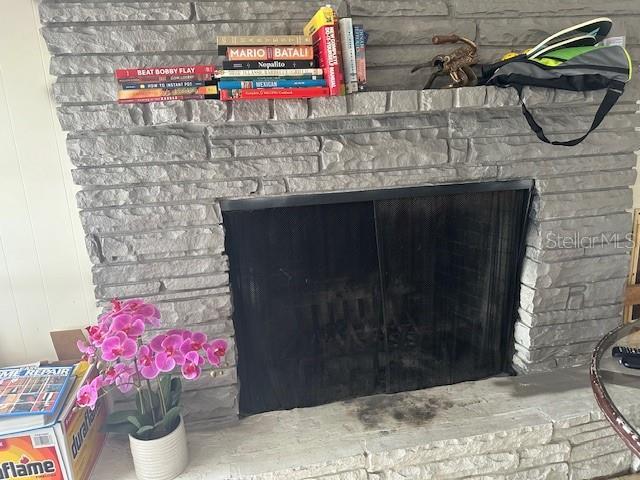 interior details with a brick fireplace