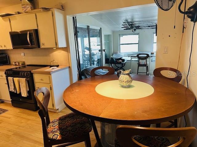 dining space featuring light wood-type flooring