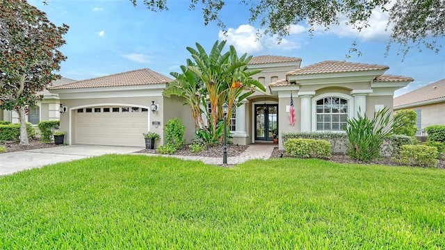 mediterranean / spanish house with a garage and a front lawn