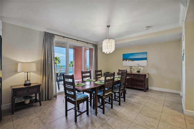 tiled dining space featuring a notable chandelier and crown molding