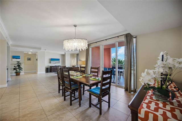 dining area with light tile patterned flooring, ornamental molding, and an inviting chandelier