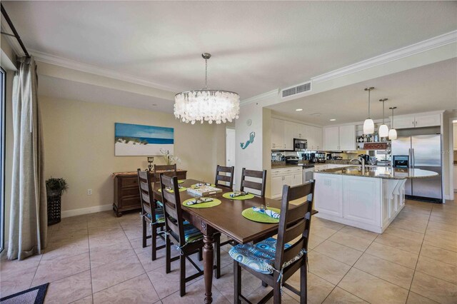 tiled dining area with an inviting chandelier, sink, and crown molding