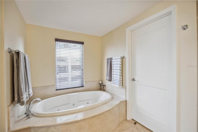 bathroom with a relaxing tiled tub and tile patterned floors