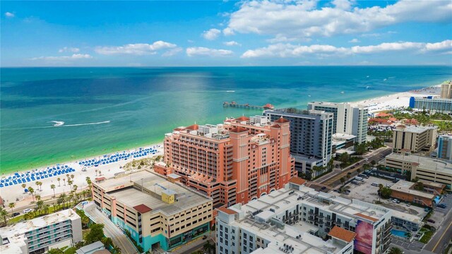 drone / aerial view featuring a water view and a beach view