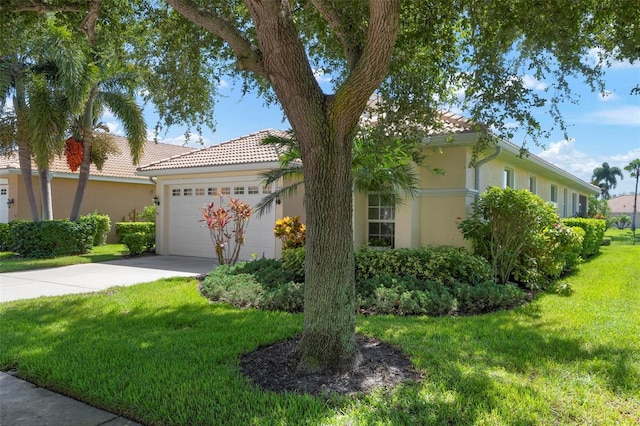 view of front of house featuring a garage and a front lawn