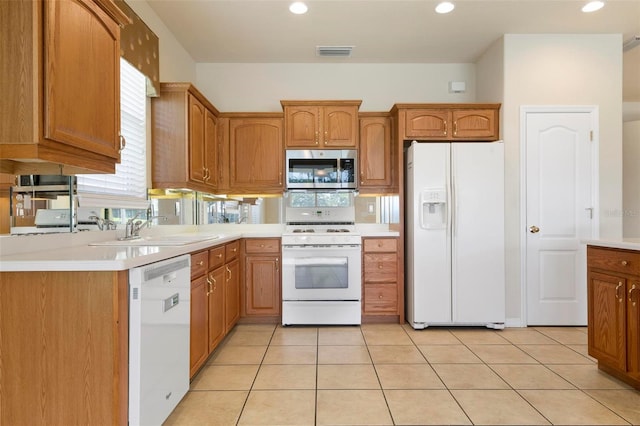 kitchen featuring sink, white appliances, and light tile patterned floors