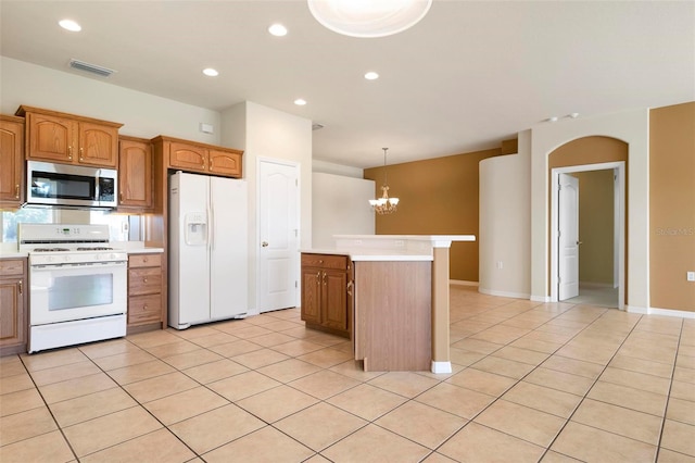 kitchen featuring a center island, white appliances, a notable chandelier, and light tile patterned floors