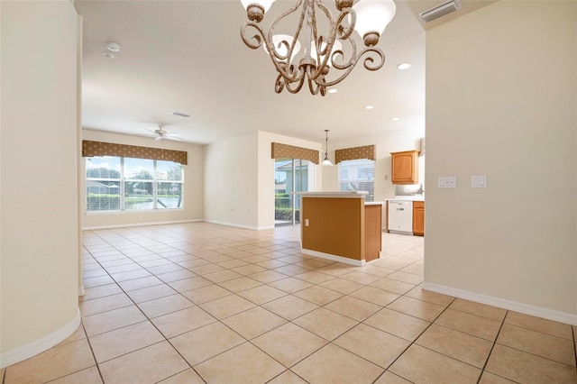 interior space featuring light tile patterned flooring and ceiling fan with notable chandelier