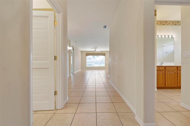 corridor featuring light tile patterned floors