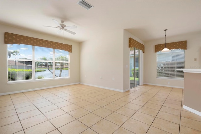 spare room featuring light tile patterned flooring and ceiling fan