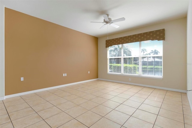 tiled spare room with ceiling fan