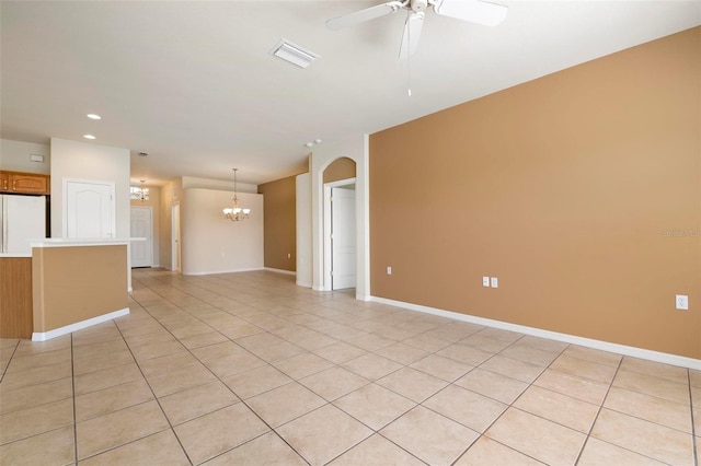 unfurnished living room with ceiling fan with notable chandelier and light tile patterned floors