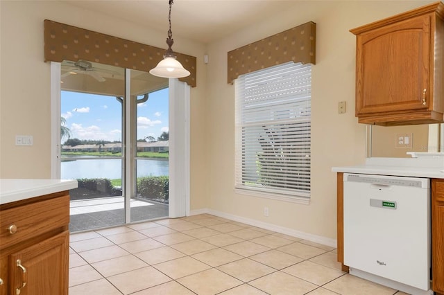 kitchen featuring white dishwasher, pendant lighting, a water view, light tile patterned flooring, and ceiling fan