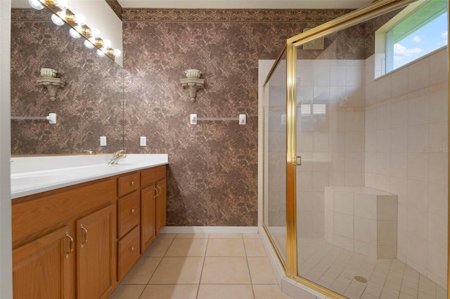 bathroom featuring tile patterned floors, vanity, and a shower with door