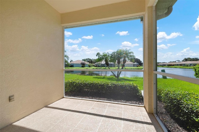 unfurnished sunroom featuring a water view and a wealth of natural light