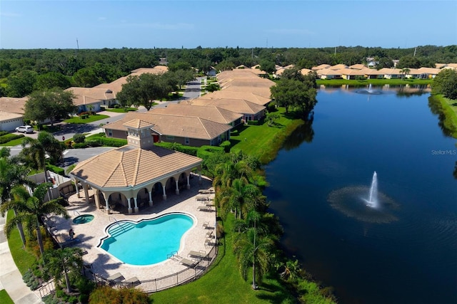 view of swimming pool featuring a patio and a water view