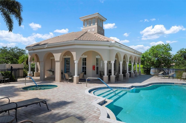 view of pool with a patio area and a hot tub