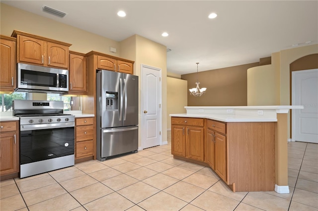 kitchen with decorative light fixtures, a center island, light tile patterned floors, a notable chandelier, and stainless steel appliances