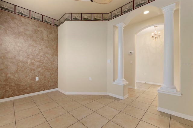 empty room with ornate columns and light tile patterned floors