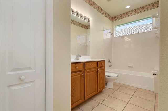 full bathroom featuring vanity, tiled shower / bath combo, tile patterned floors, and toilet