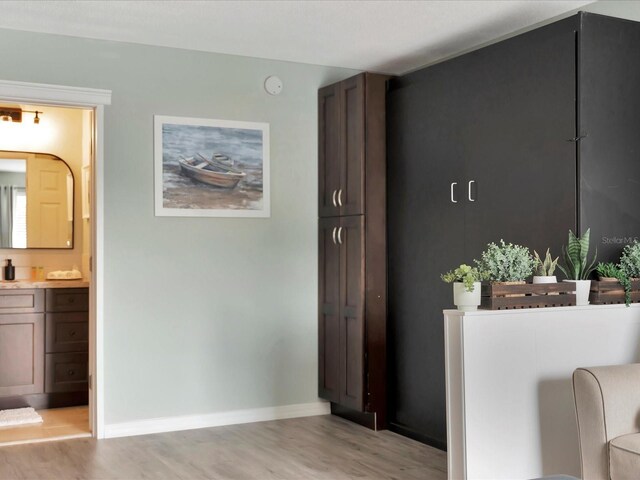 corridor with light hardwood / wood-style floors