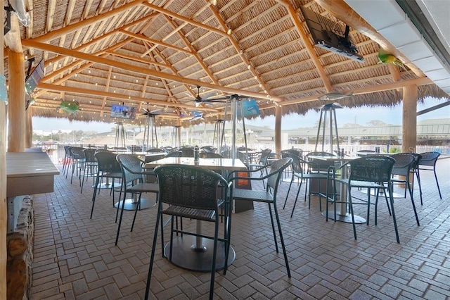 view of patio / terrace featuring a bar, a gazebo, and ceiling fan