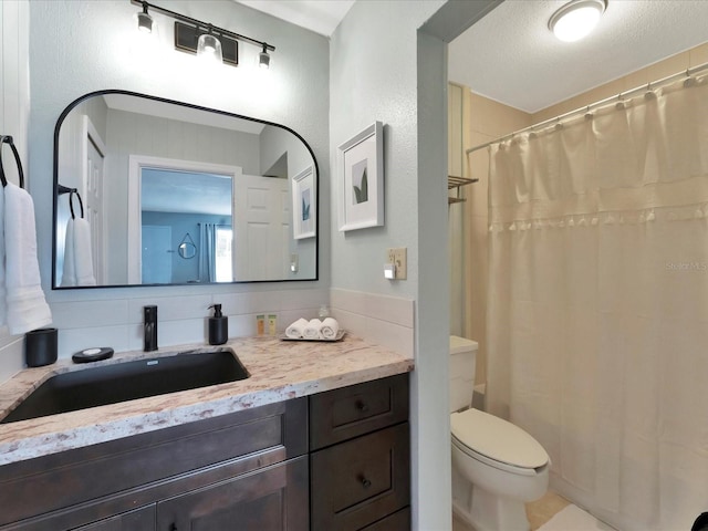 bathroom with tasteful backsplash, a textured ceiling, tile patterned floors, toilet, and vanity