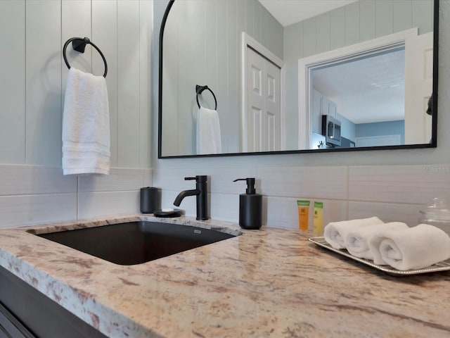 bathroom with vanity and backsplash