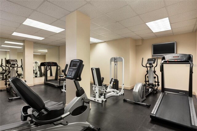 gym with a paneled ceiling