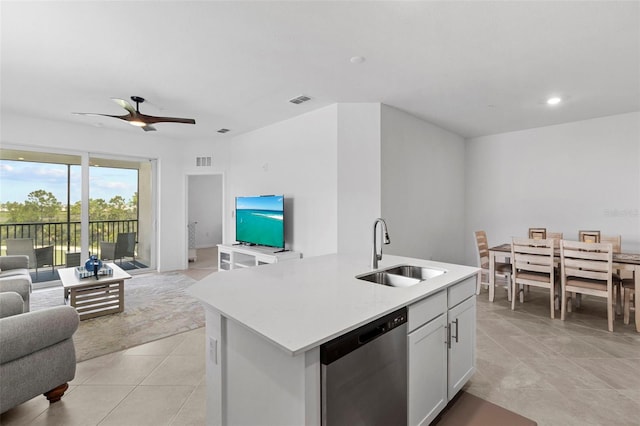 kitchen featuring ceiling fan, an island with sink, sink, white cabinetry, and dishwasher