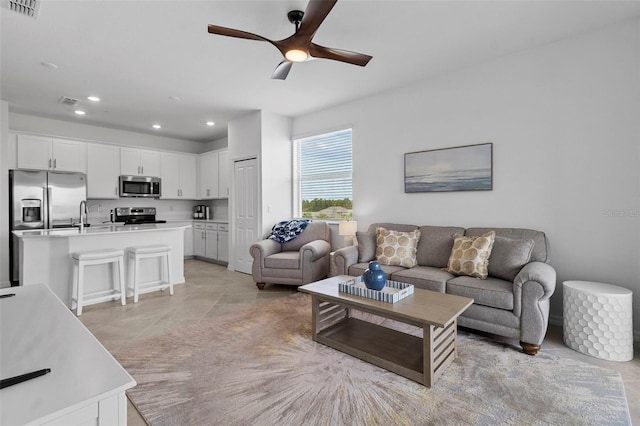 living room with recessed lighting, visible vents, ceiling fan, and light tile patterned floors