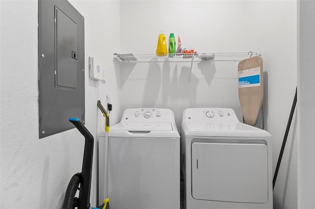 washroom featuring laundry area, electric panel, and washer and dryer