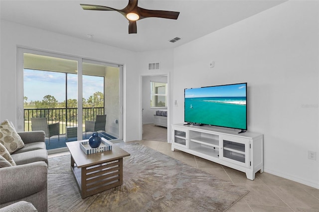 tiled living room with ceiling fan