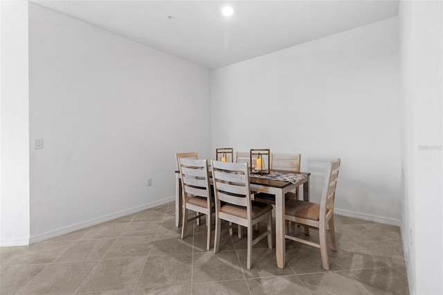 dining space with light tile patterned floors and baseboards