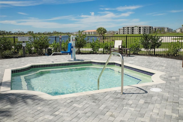 view of swimming pool featuring a patio area, fence, and a pool