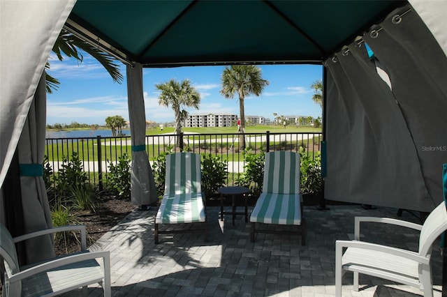 view of patio featuring fence and a gazebo