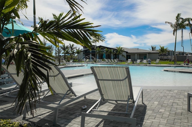 community pool with a patio area and a jacuzzi