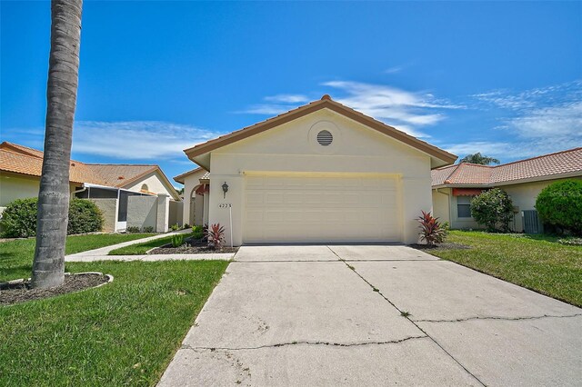 single story home featuring a garage and a front yard