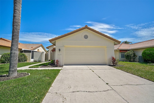 single story home with central AC unit, a garage, and a front yard