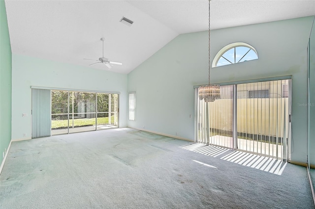 unfurnished living room with a wealth of natural light, carpet, and high vaulted ceiling