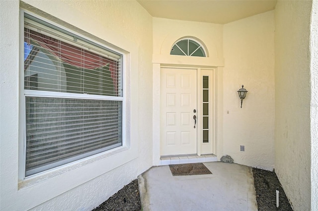 view of exterior entry with stucco siding